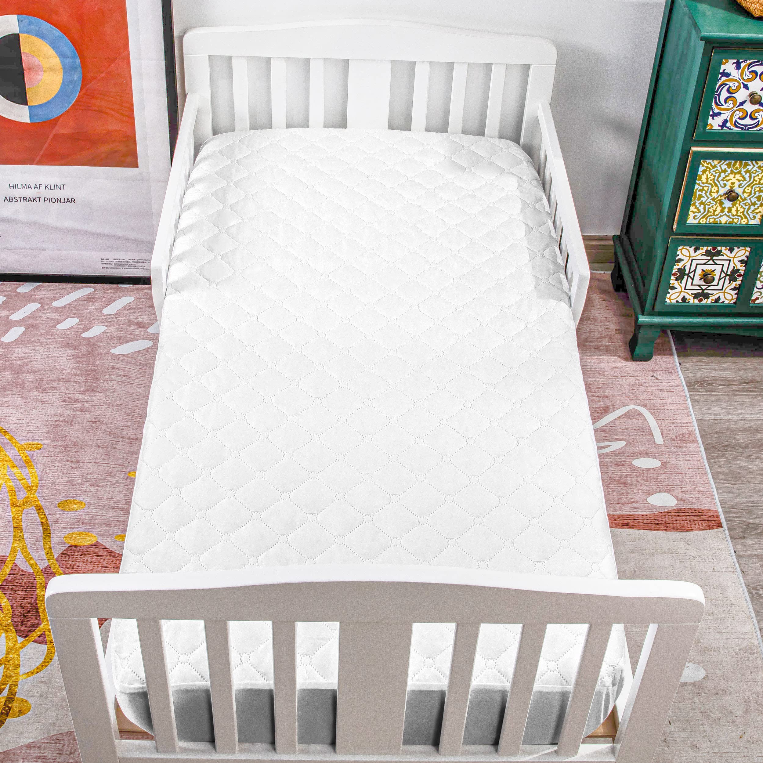 NTBAY white mini crib mattress pad offers soft and quiet protection.