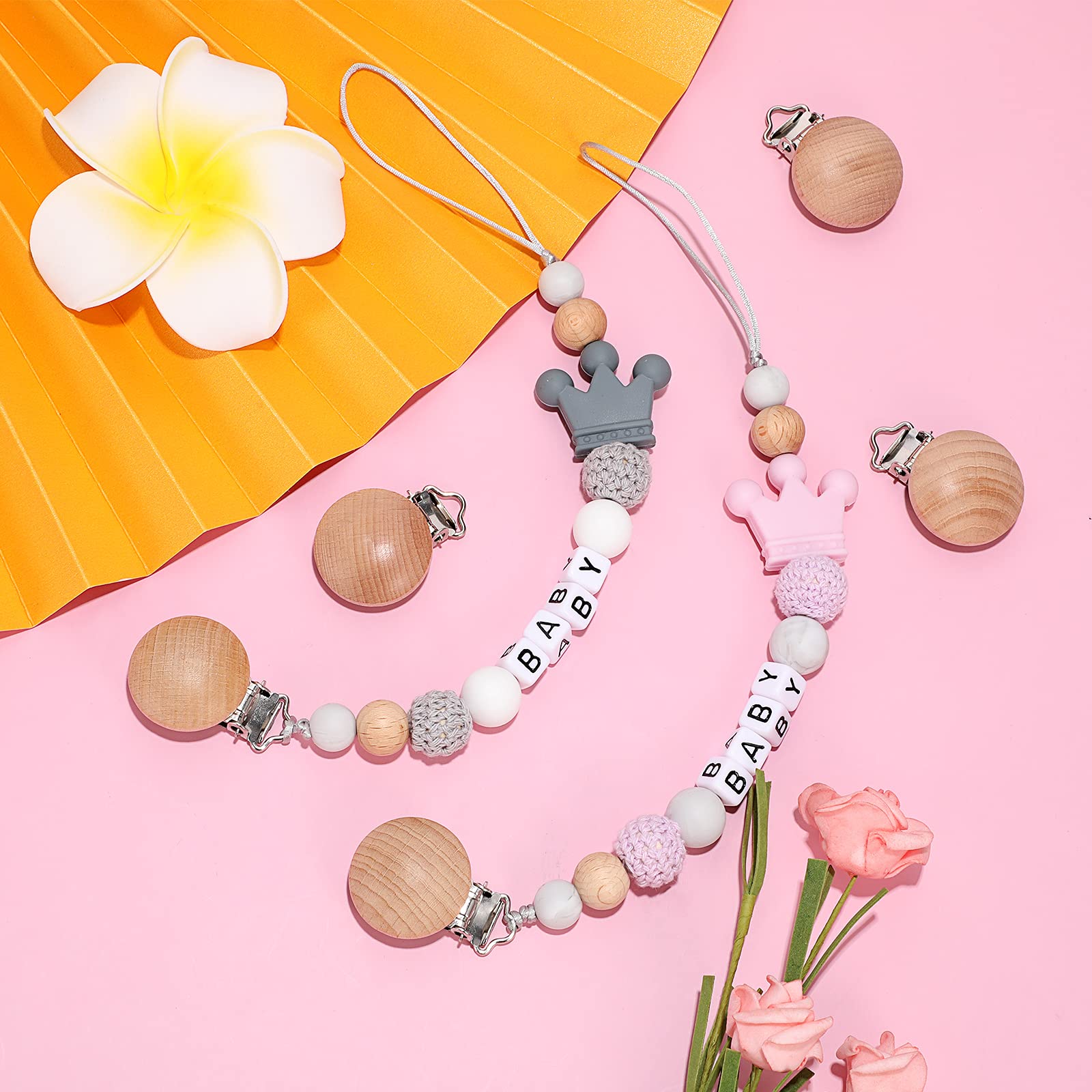 Nuanchu pacifier clips attached to a stroller for on-the-go convenience