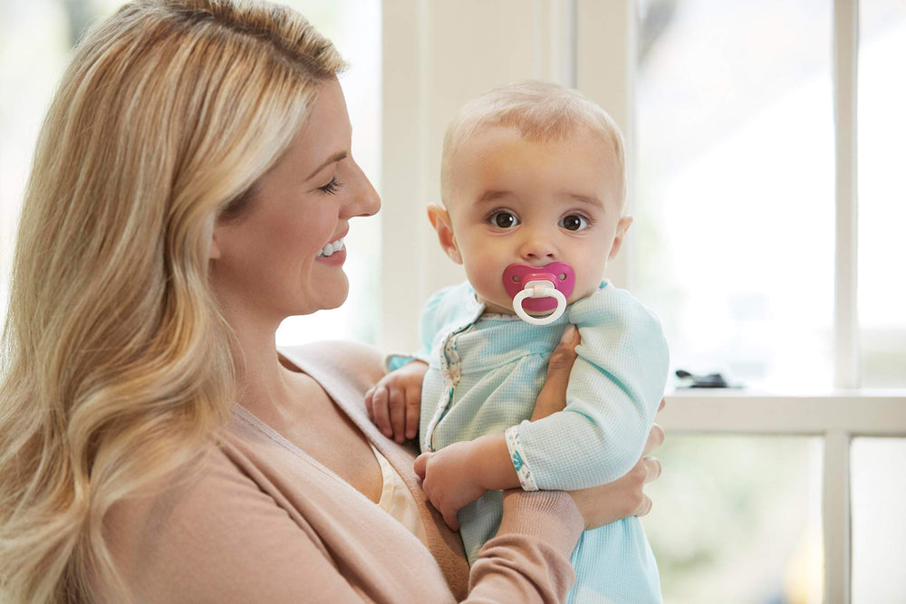 Baby using NUK orthodontic pacifier for comfort and transition.