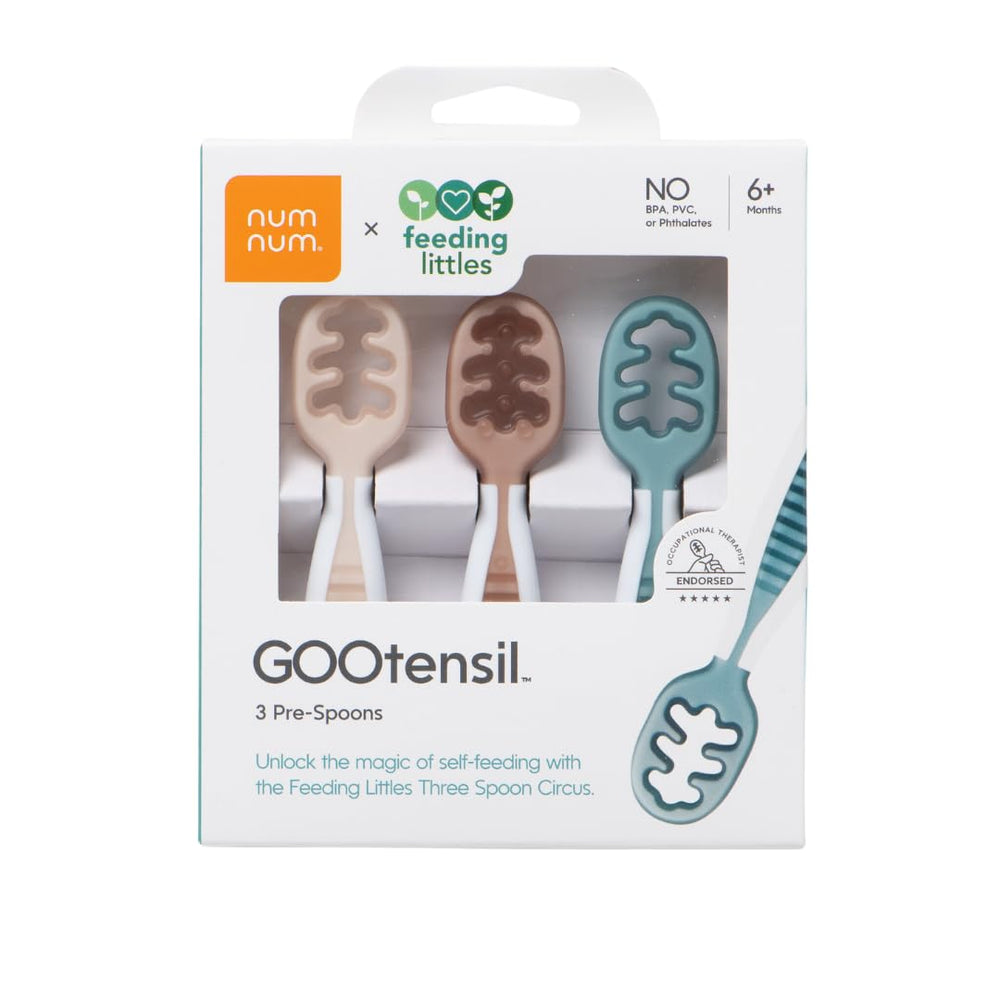 NumNum GOOtensils stage-one teether spoon easing gums and starting self-feeding.