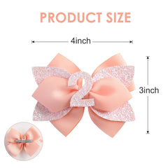 Nuolich peach bow with glitter sequin number enhances party-ready looks for young children.