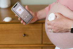 Olababy Bellytunes Lite with AirPods setup enables hands-free listening.