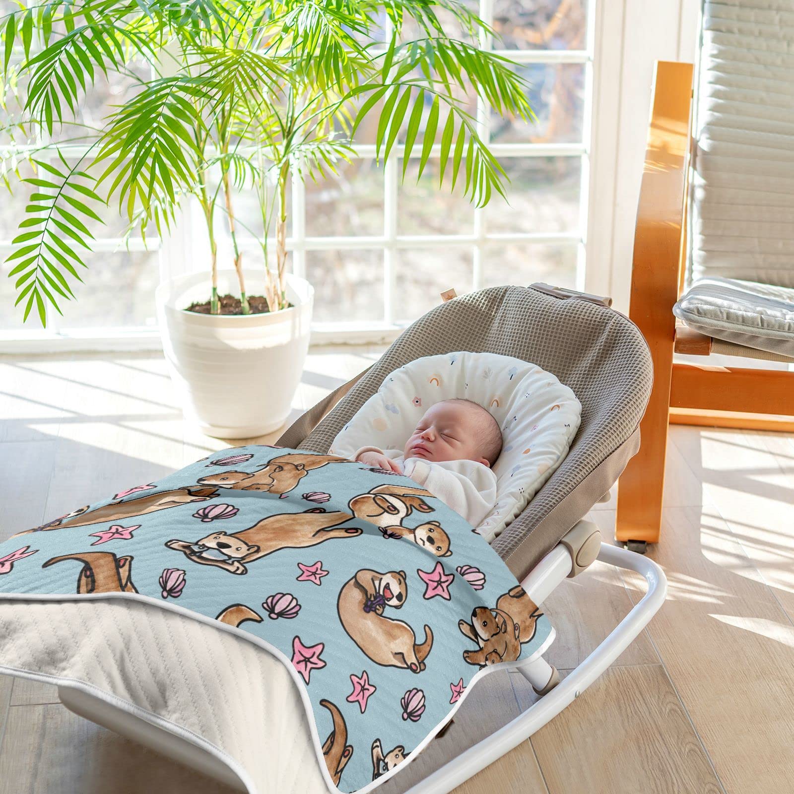 Ollabaky Otters blanket presented as a gift for new parents.