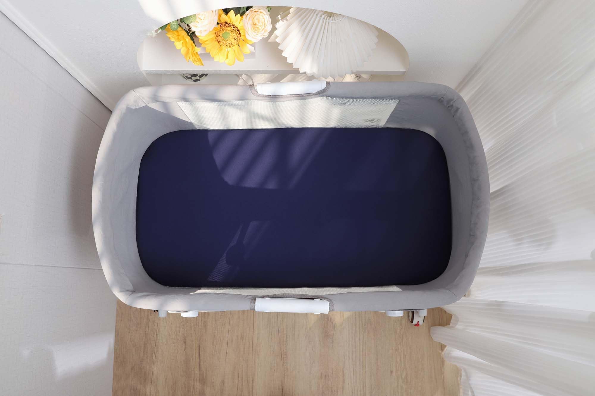 Onacosht gender-neutral navy and fog grey sheets complement any nursery.