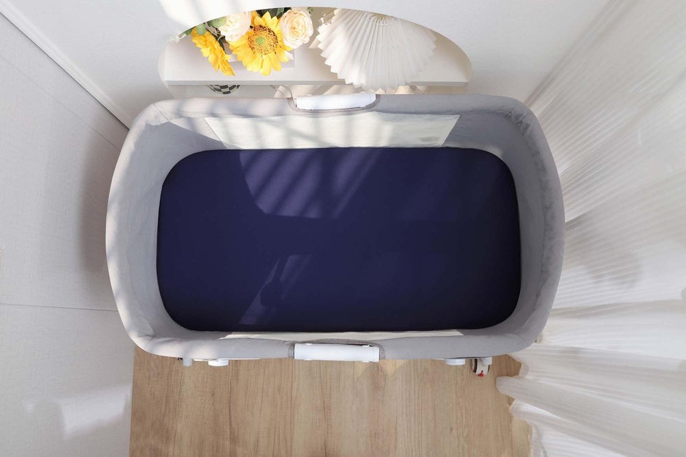 Onacosht gender-neutral navy and fog grey sheets complement any nursery.