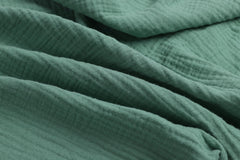 Close-up of soft cotton muslin texture on Onacosht bassinet sheets