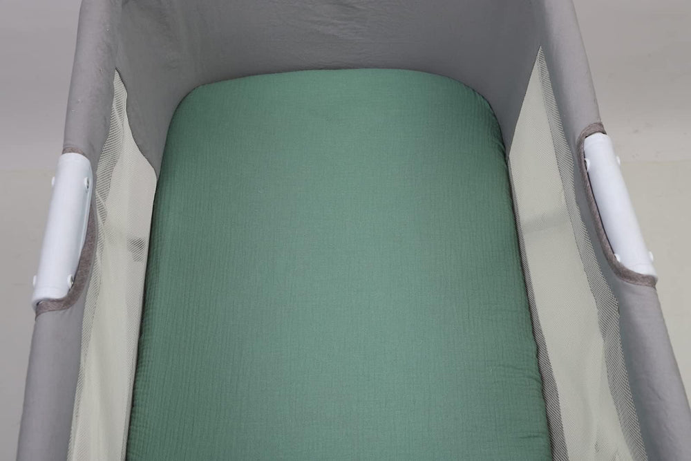 Solid green Onacosht bassinet sheet coordinating with nursery textiles