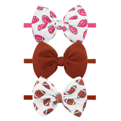 ONENINEDREAM pink football bow headband for newborns, ideal for sporty outfits.
