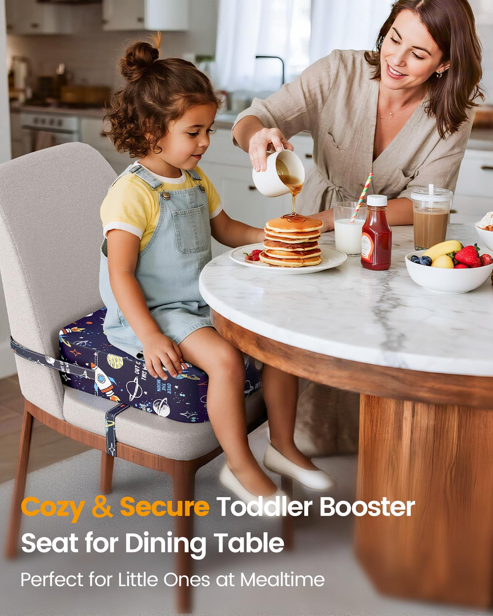 OPZAVYA blue rocket pattern booster seat in use during meals for independent eating