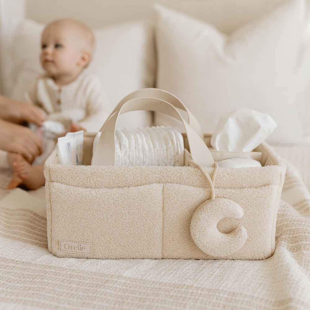Orelle Bouclé Diaper Caddy Moon Pendant detail adds playful charm during diaper changes.
