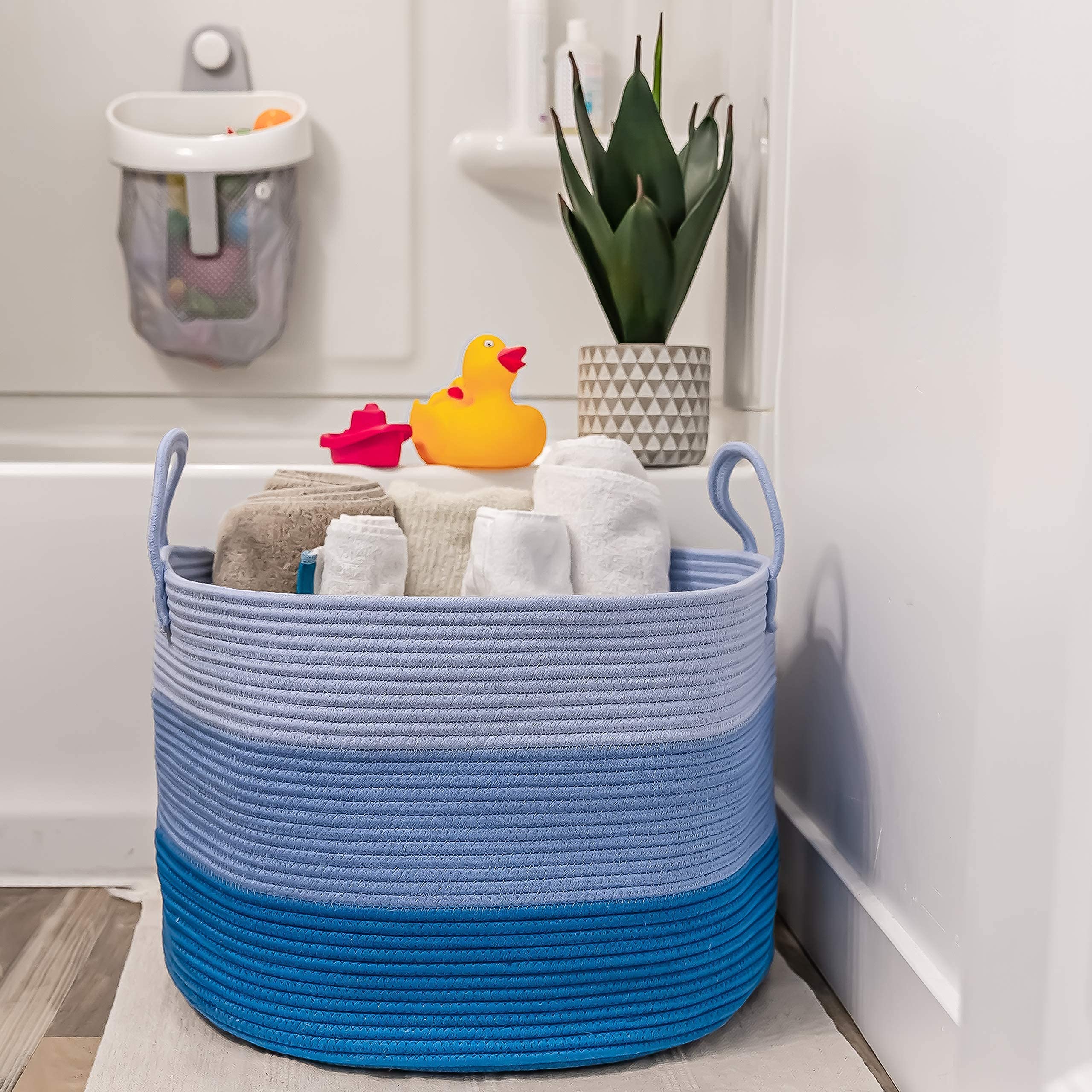 OrganiHaus soft-texture blue basket resting on a clean floor.