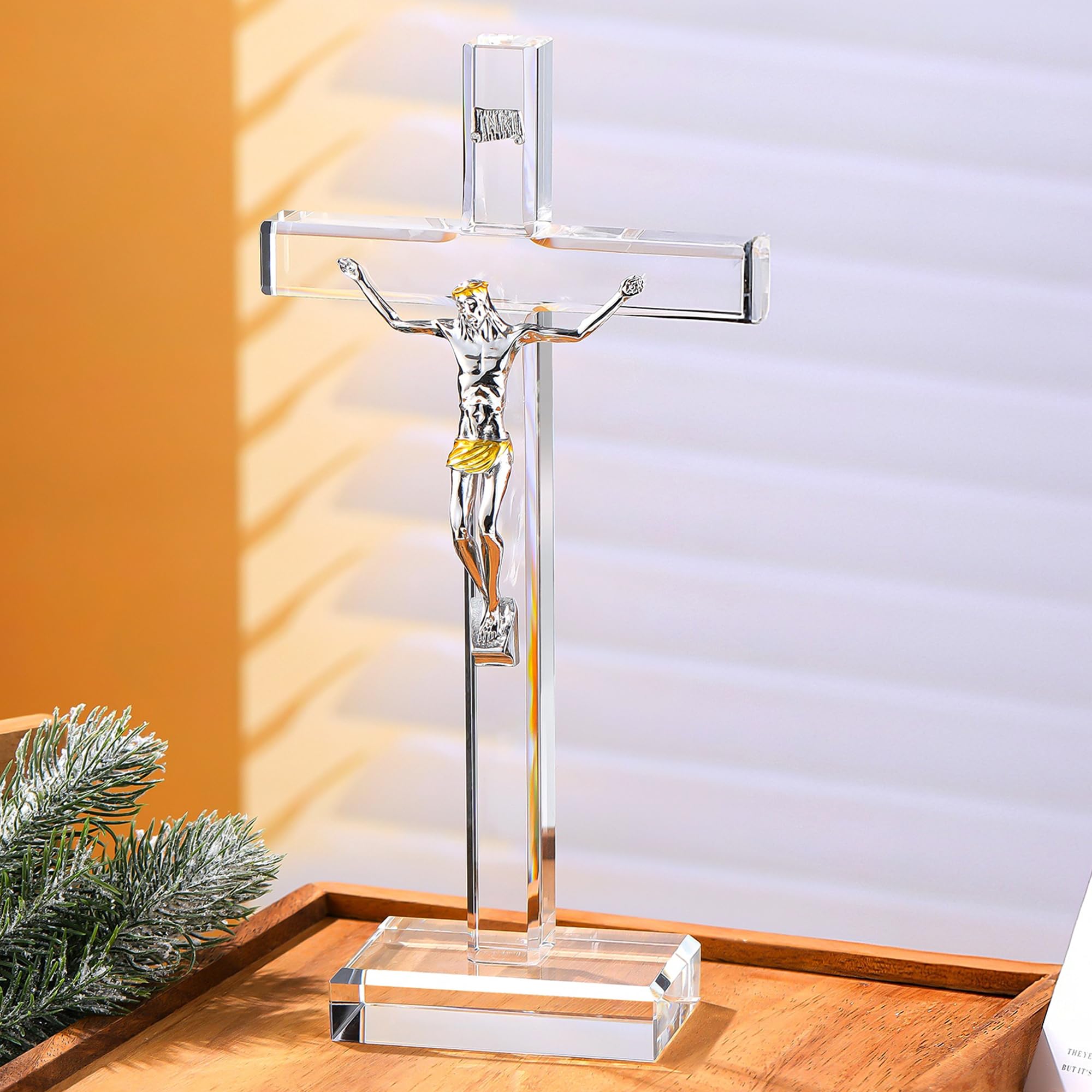Ornalrist standing crystal cross 10in reflecting rainbow light on a shelf