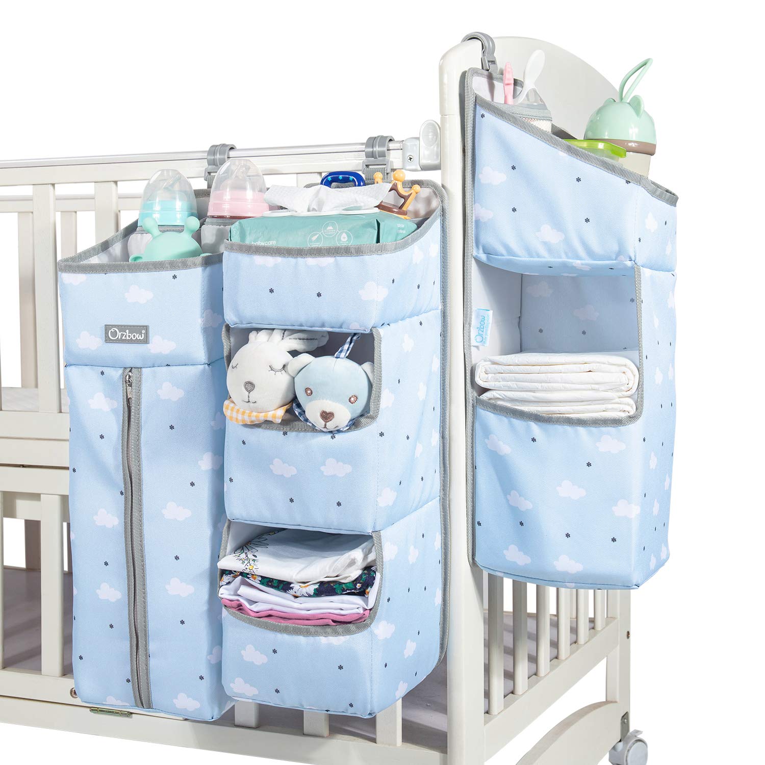 Orzbow diaper caddy hanging on crib with roomy compartments for quick access.