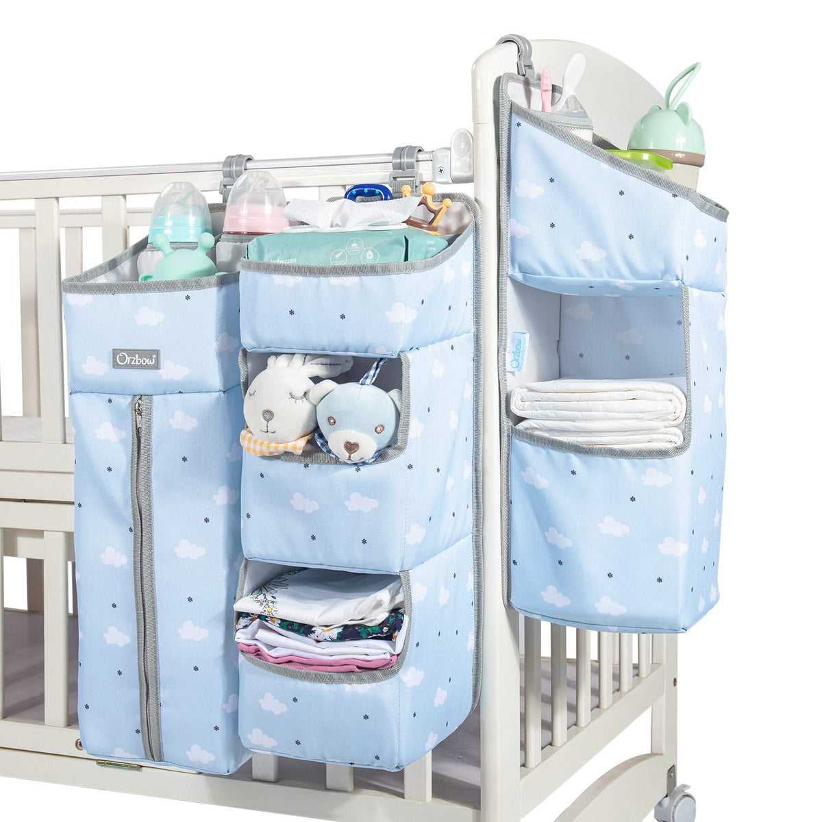 Orzbow diaper caddy hanging on crib with roomy compartments for quick access.