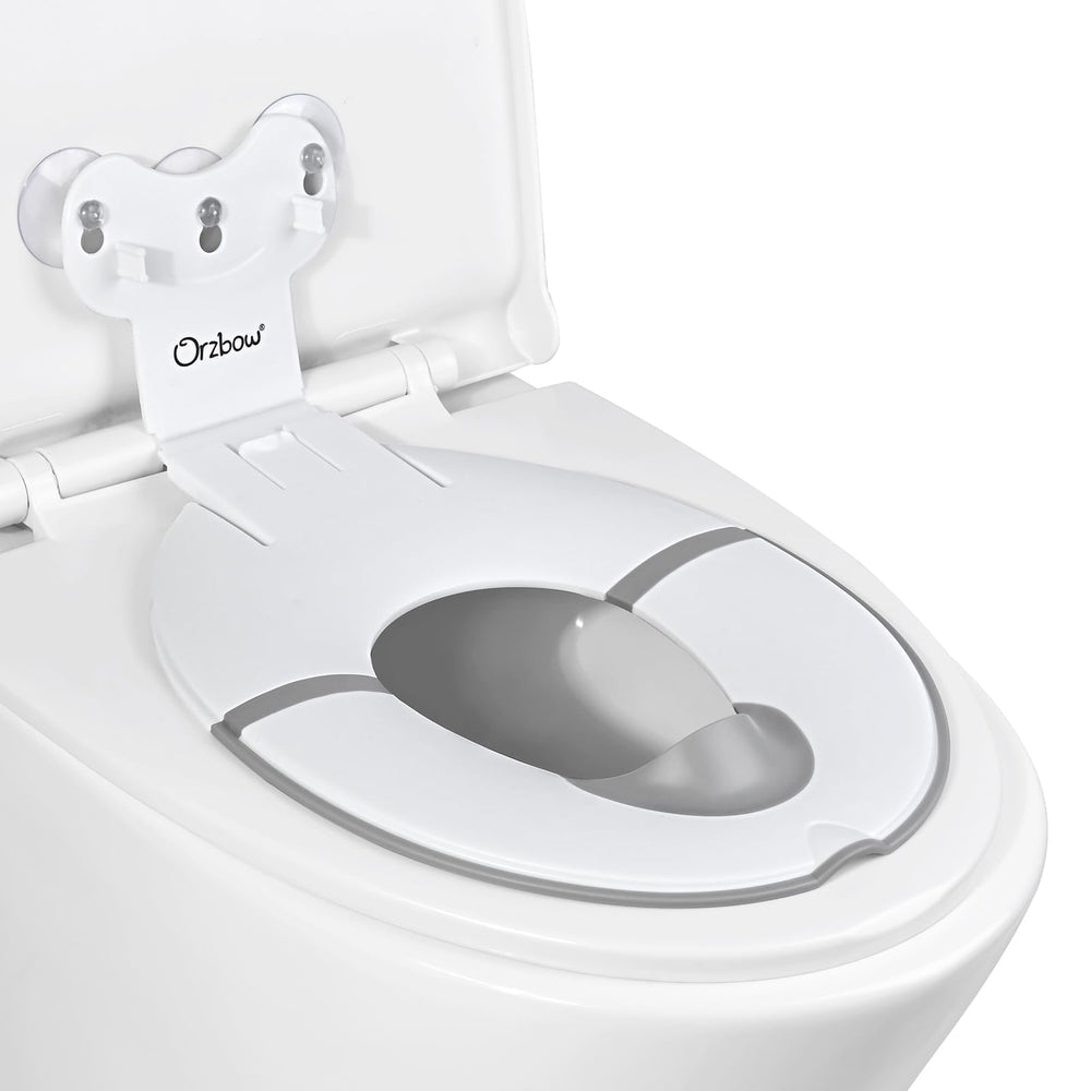 Orzbow foldable potty seat with suction cups securely attached to toilet lid.