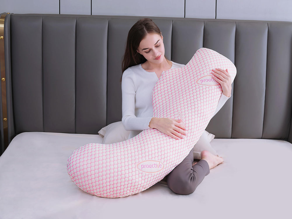 Oternal pregnancy pillow in use illustrates back and leg support