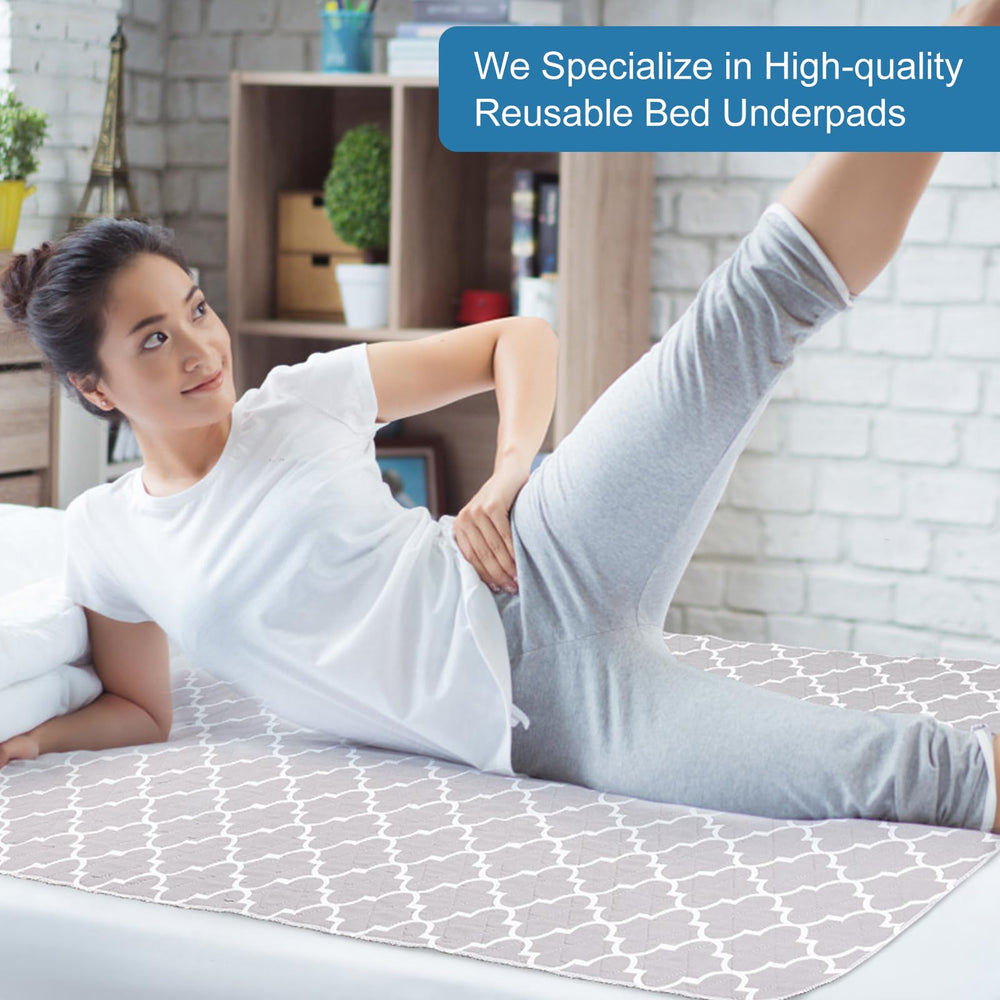 OUTCREATOR bed pad in use on a bed, color gray.