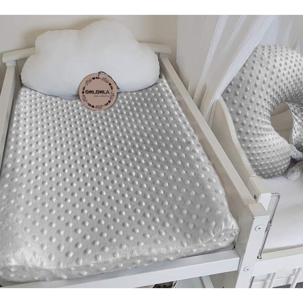 Owlowla changing pad cover is machine washable for easy cleanup after messy changes.