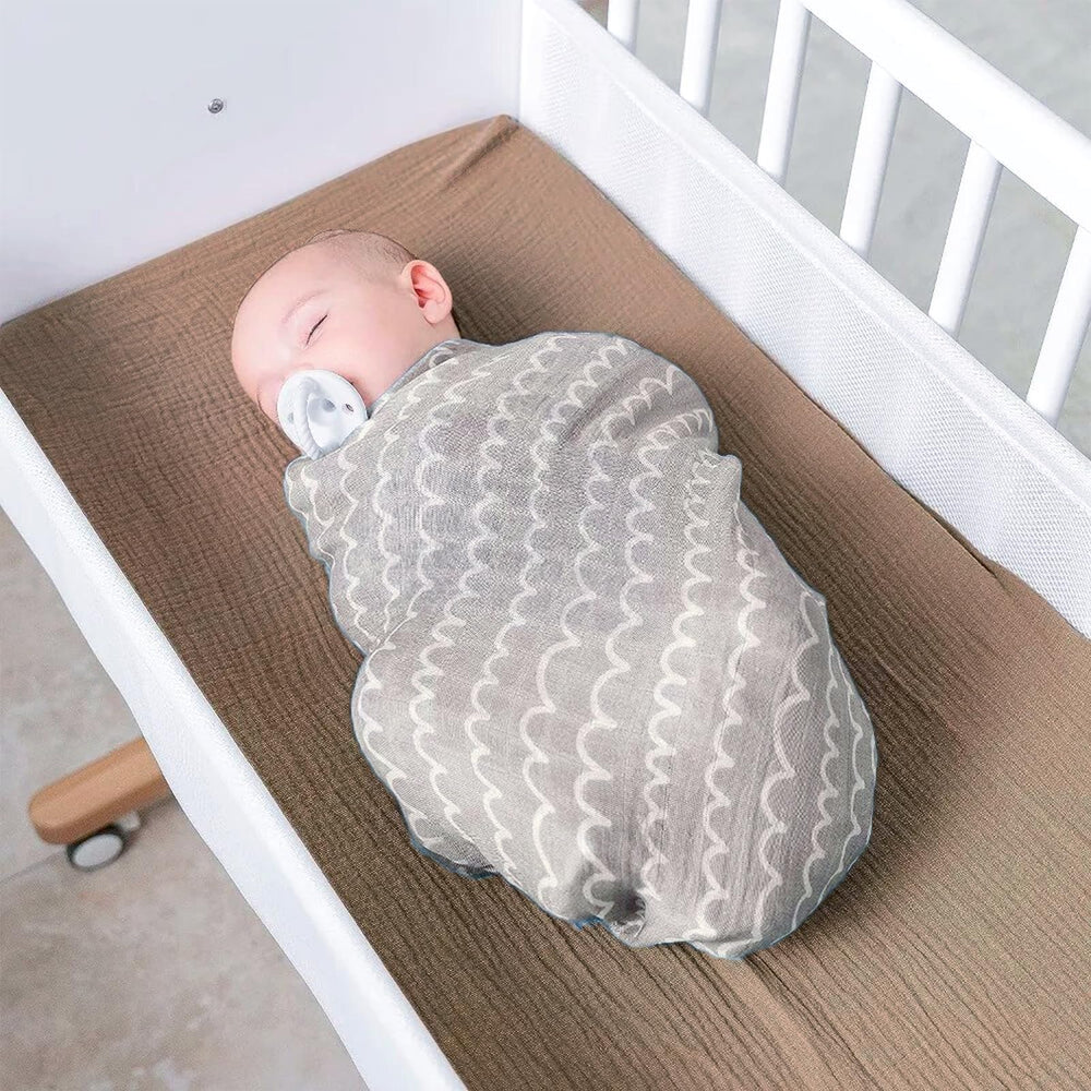 Owlowla two-pack muslin covers in natural tones for versatile nursery use.