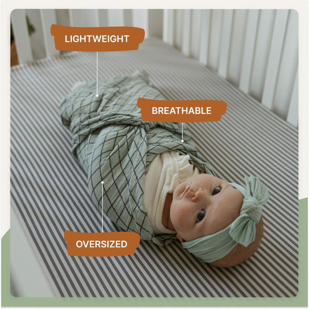 Parker Baby Co sage swaddle shown as stroller cover during a sunny outing