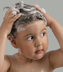 Close-up of Paul Mitchell Baby Don't Cry foam for gentle bath time.