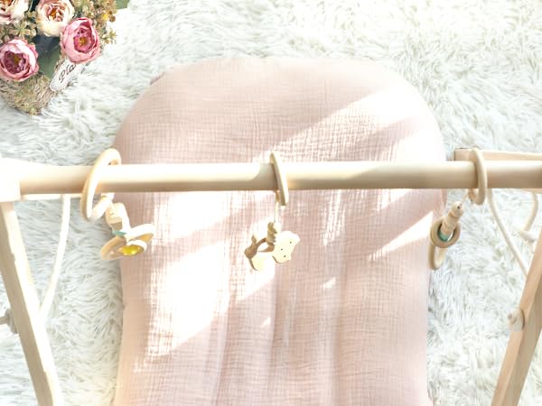 Pink shade protects Snuggle Me area while complementing nursery decor.