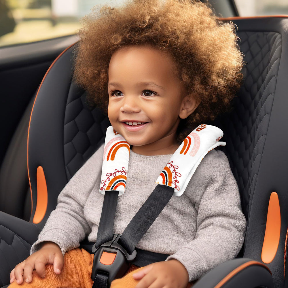 Pea Pod strap cover in use with car seat for gentle protection.