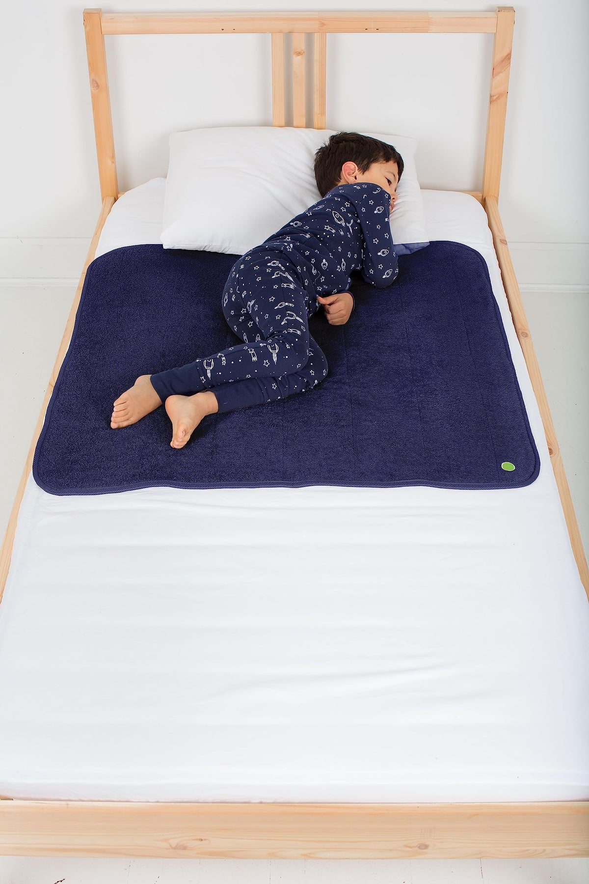 PeapodMats bedwetting mat with waterproof layer protects sheets overnight.