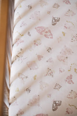 Pehr Daydreamer crib sheet on standard crib mattress showing snug elastic fit