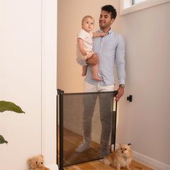 Perma Child Safety retractable gate extended to fit 55 inches for wide openings.