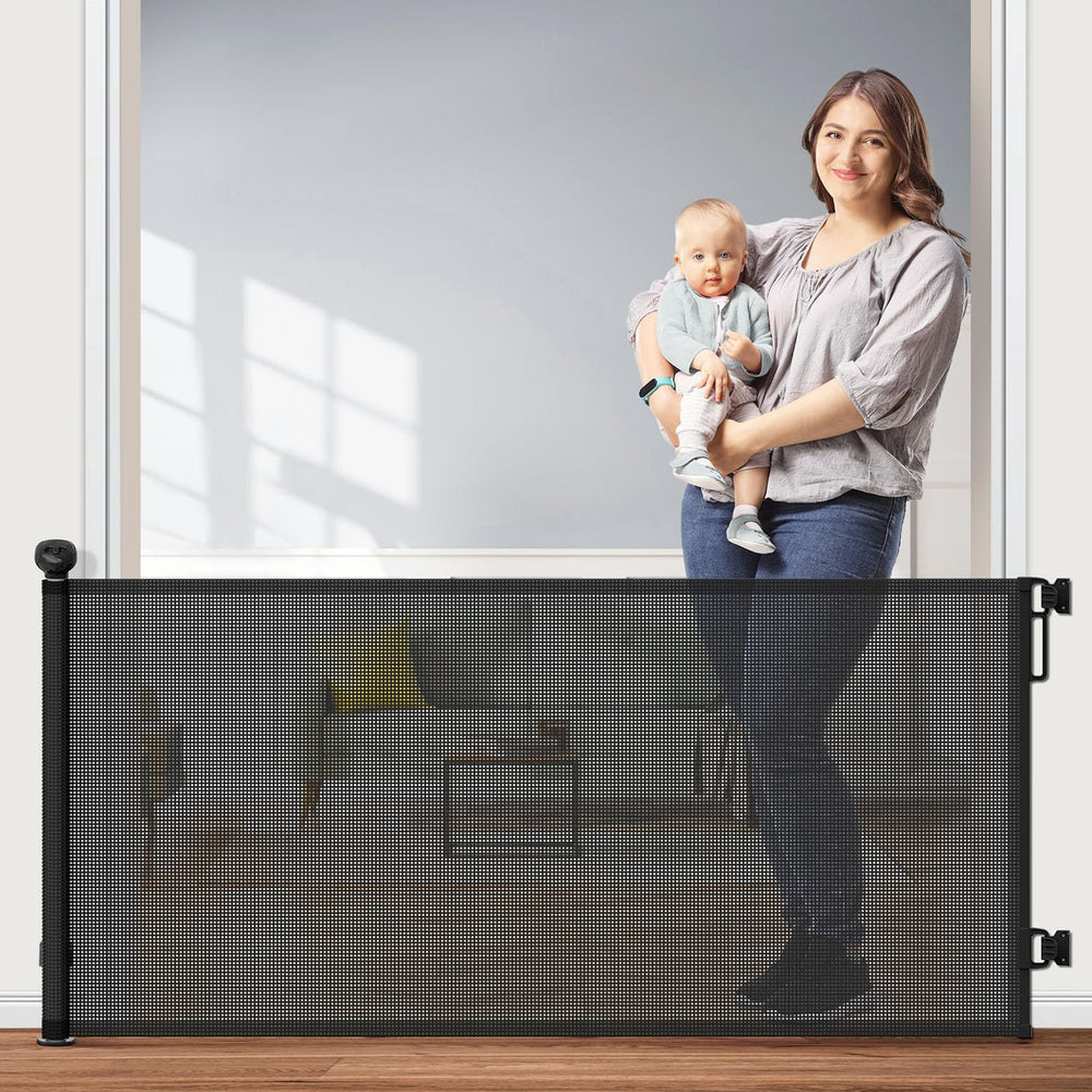 Petstars retractable gate mesh extended across doorway for pet and child safety