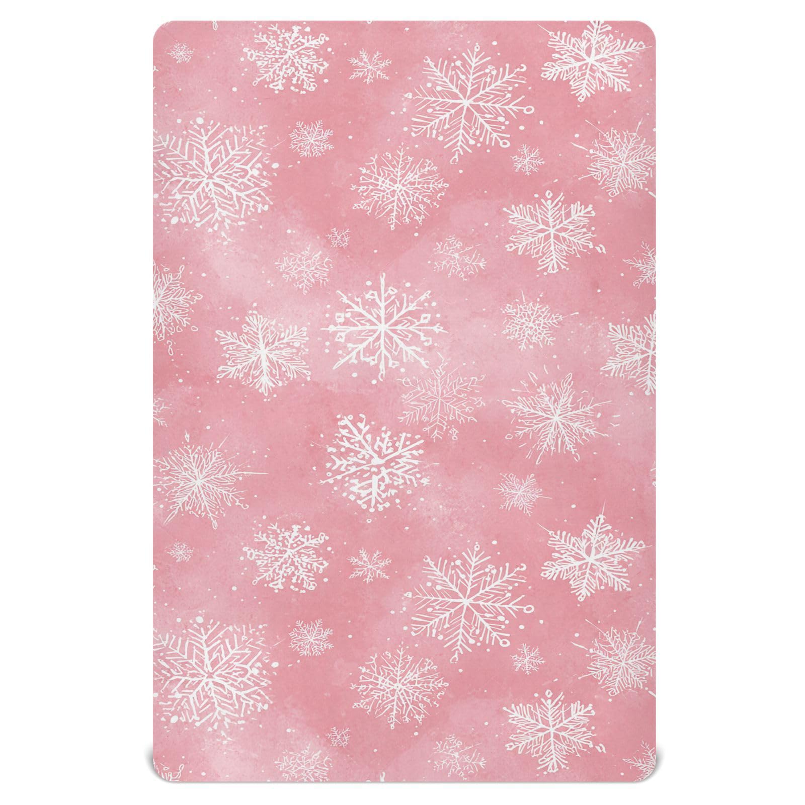 Pfrewn Christmas crib sheet with pink retro snowflakes on a mini crib for cozy naps