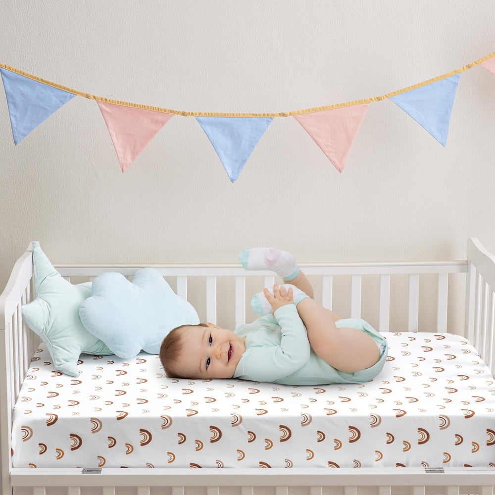 PHF rainbow crib sheet shown snug elastic edge on mattress