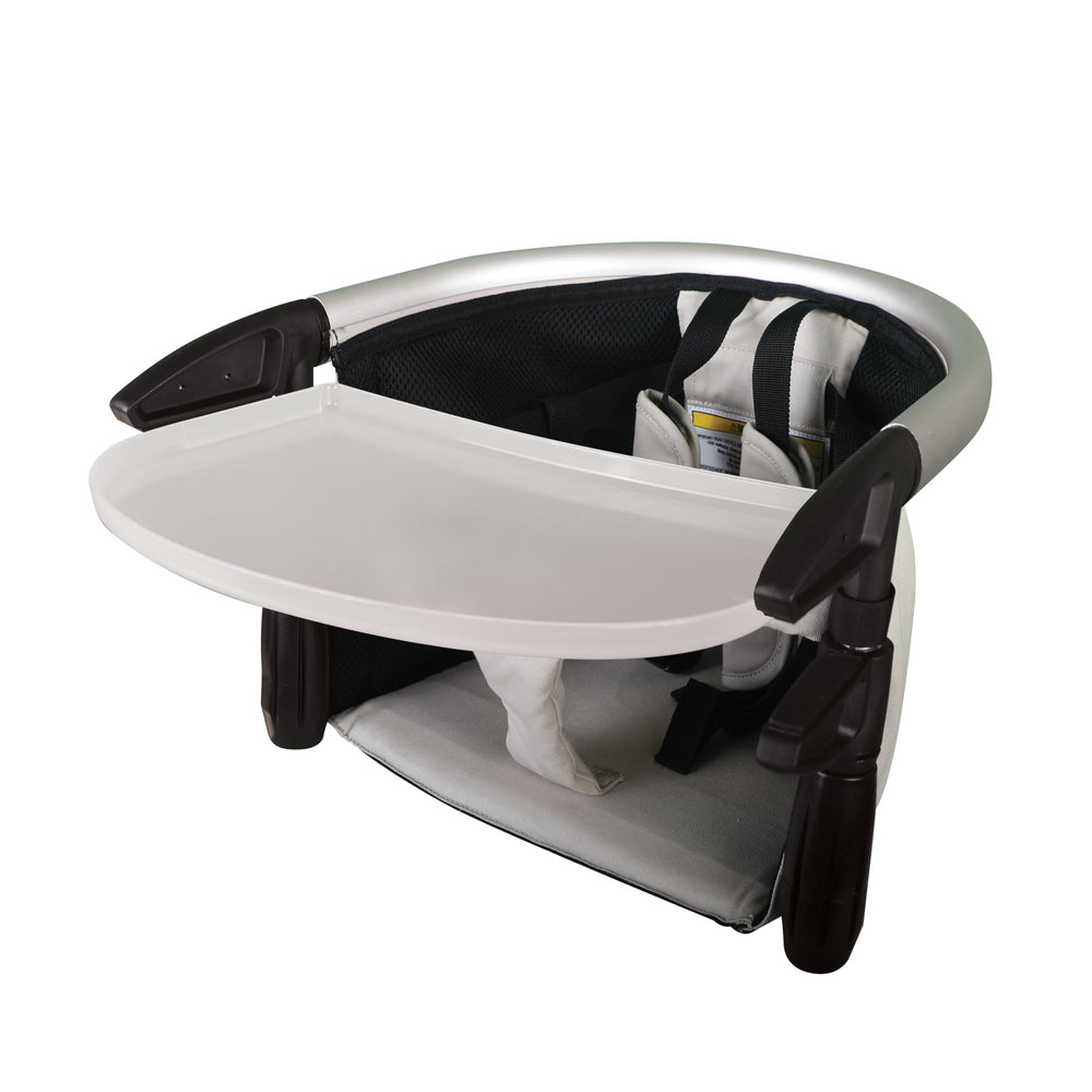 Phil&teds Lobster clip-on high chair frame attached to a table for portable dining.