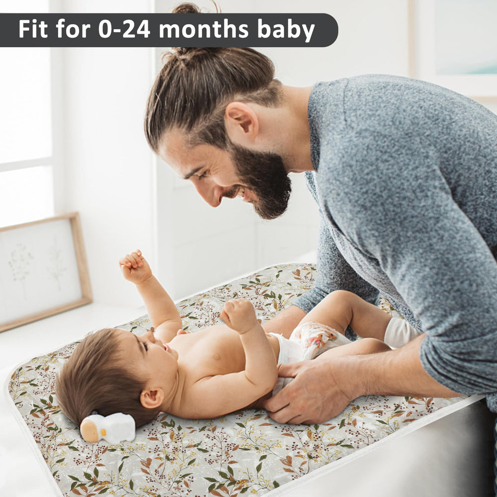 PHOEBUS BABY changing pad in use on a changing table with absorbent layers.
