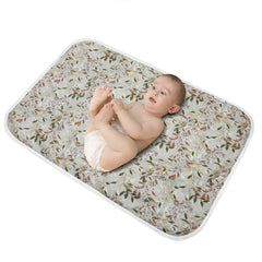 PHOEBUS BABY changing pad with leaf pattern on top offers a soft cotton surface.