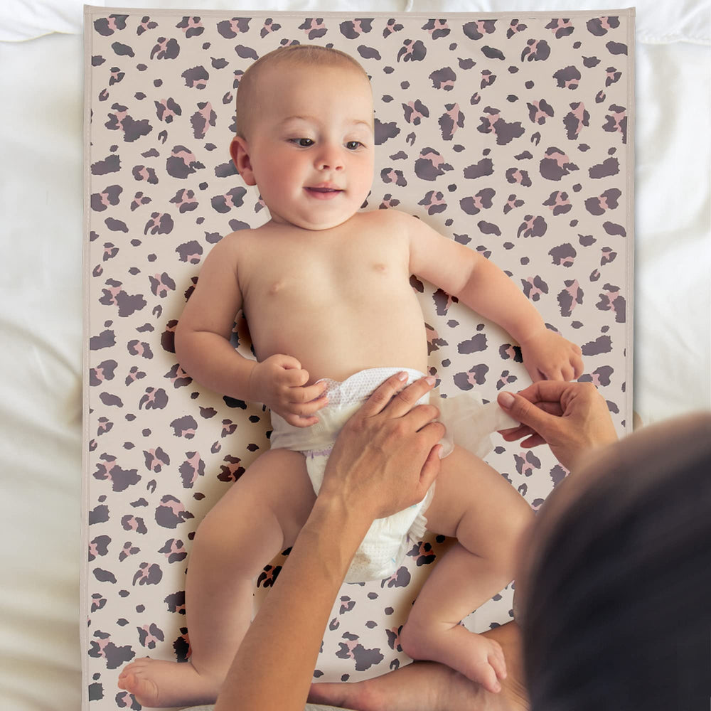 Phoebus Baby foldable travel changing mat in leopard design, fits in bags.