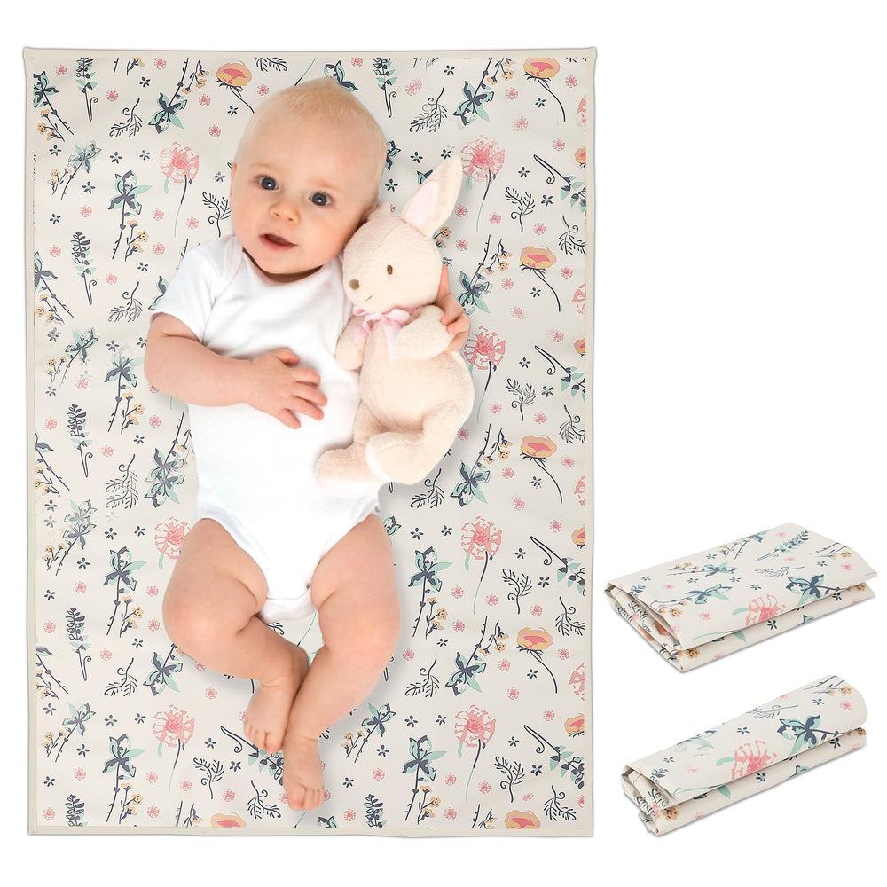 Phoebus Baby vegan leather changing mat, floral design, open for quick diaper changes.