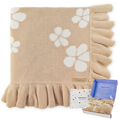Pinuotu cotton baby blanket with ruffled edges provides gentle warmth and comfort.