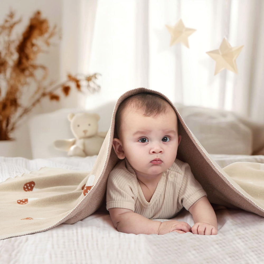 Pinuotu Mushroom Blanket swaddle-ready in cozy newborn setup.