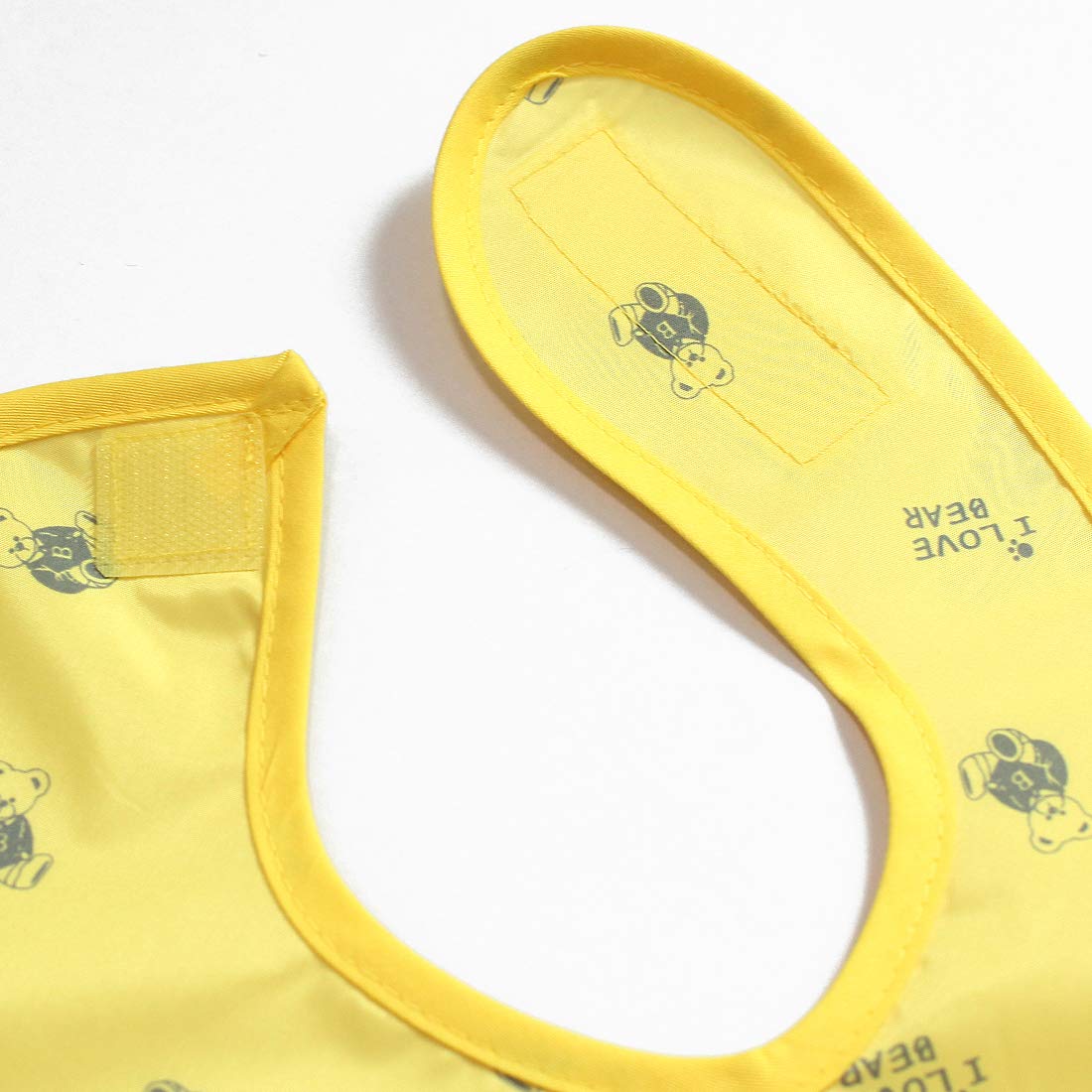 Plie yellow bear bib lightweight design minimizes burden during meals.