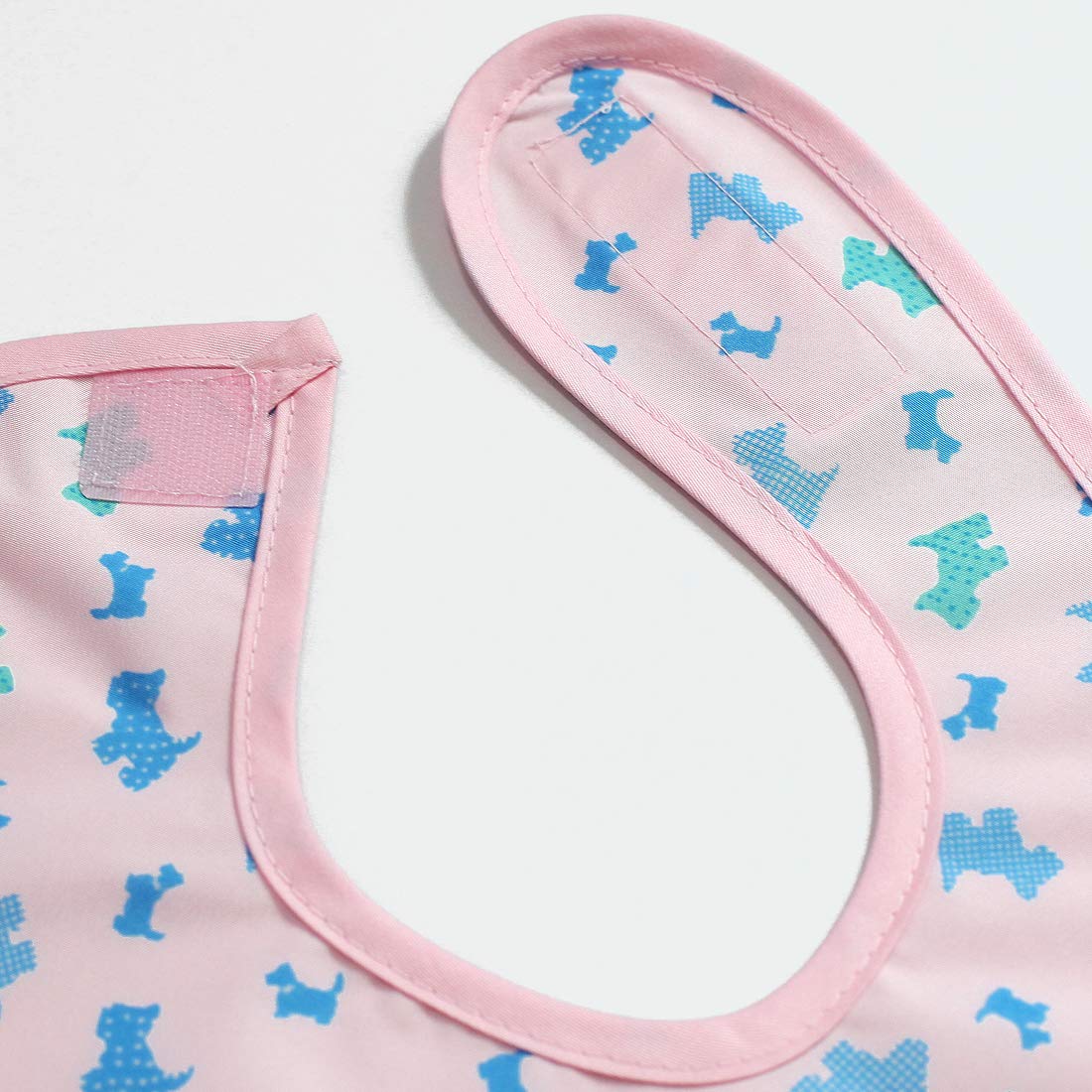 Plie pink puppy-pattern bib with Velcro neck for easy adjustments