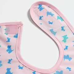 Plie pink puppy-pattern bib with Velcro neck for easy adjustments