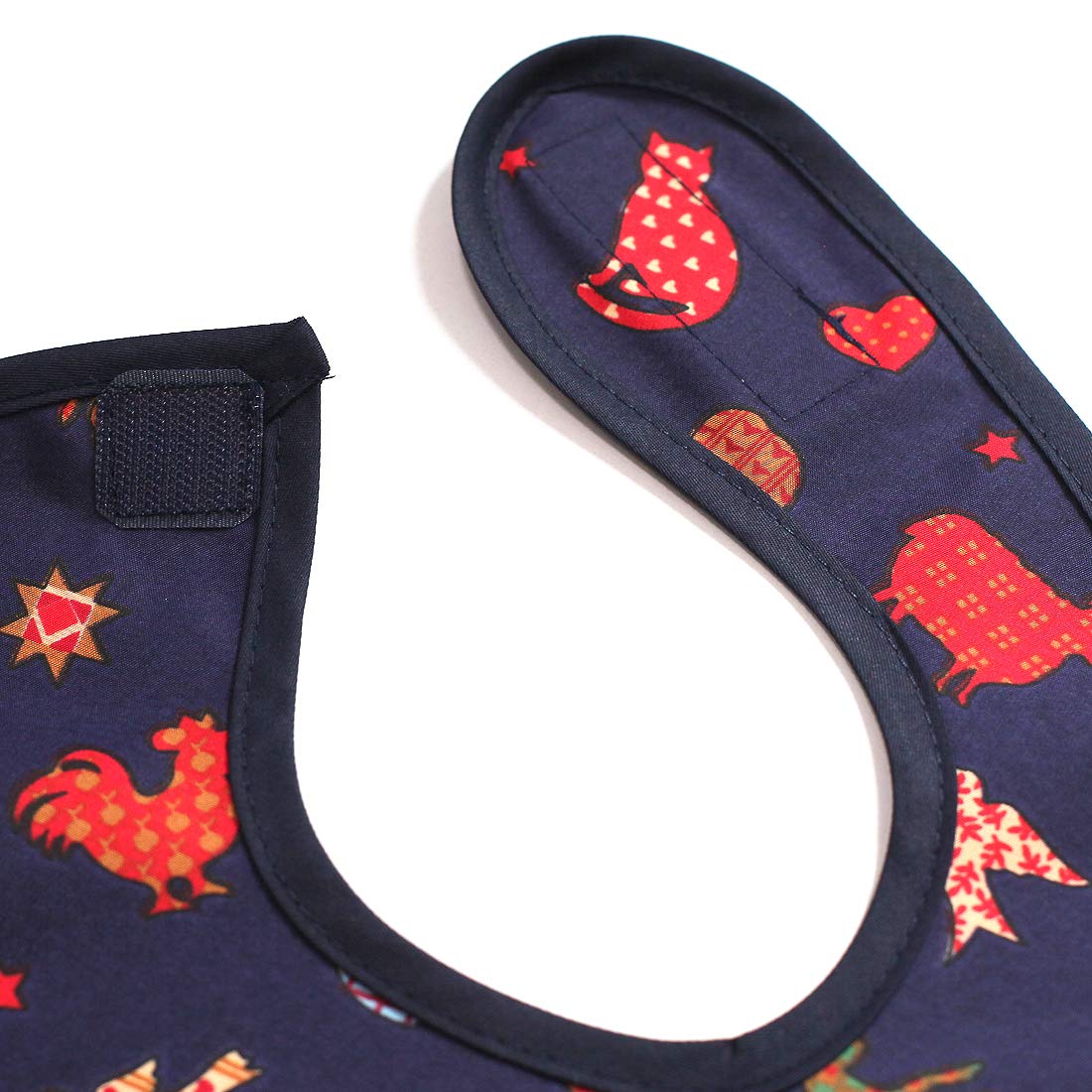 Plie waterproof sleeved bib Navy Zoo supports self-feeding at home.