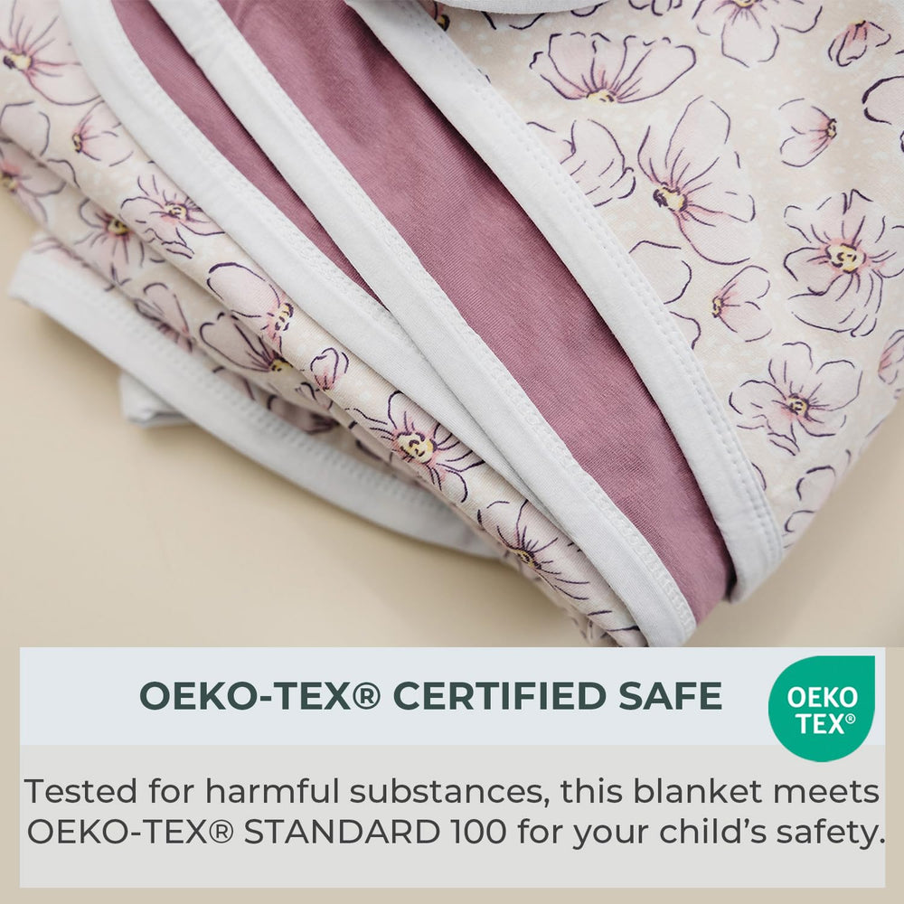 Pobibaby Blossom blanket on couch offers cuddling and comfort.