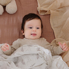 POMISO muslin swaddle close-up shows breathable cotton texture for soft skin