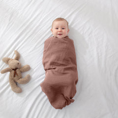 POMISO muslin swaddle in a nursery scene supports everyday swaddling and cuddles