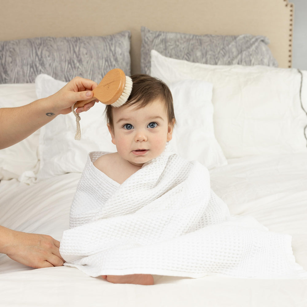 Pondering Pine cradle cap brush with goat hair soothes tiny scalps.