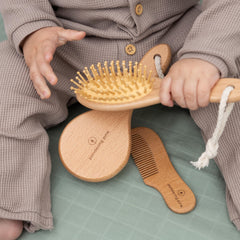 Pondering Pine wooden-handle baby brush with beech and pear wood for gentle grooming.