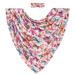 Posh Peanut watercolor butterfly nursery scene featuring the swaddle as decor and comfort.